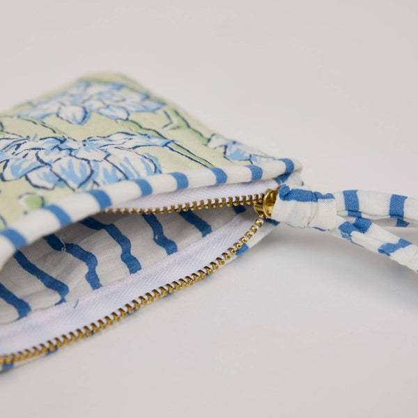 Cosmetic bag with a green, blue and white pattern on a light background