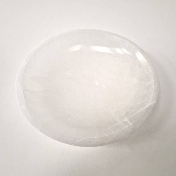 Round white crystal bowl on a light gray background