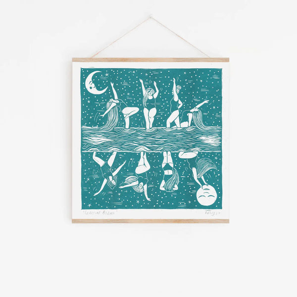 Framed artwork of women in a pool with a moonlit sky.