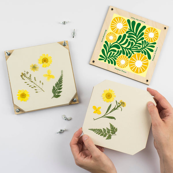 Handmade wooden stencils with floral designs on a white background