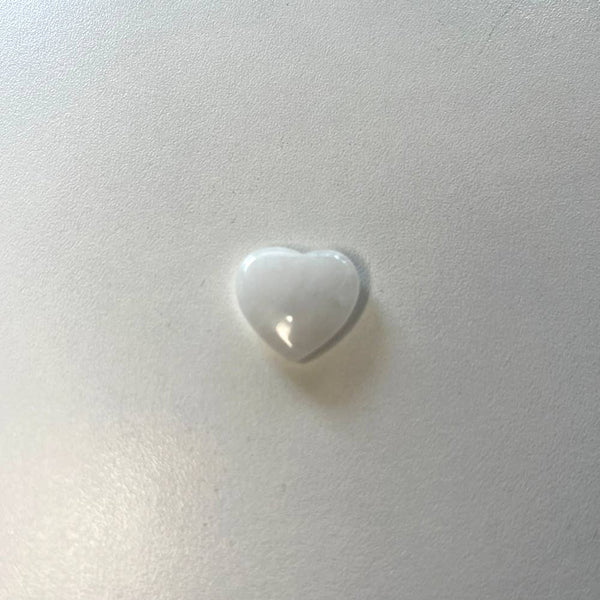 Clear Quartz heart-shaped crystal on a white background