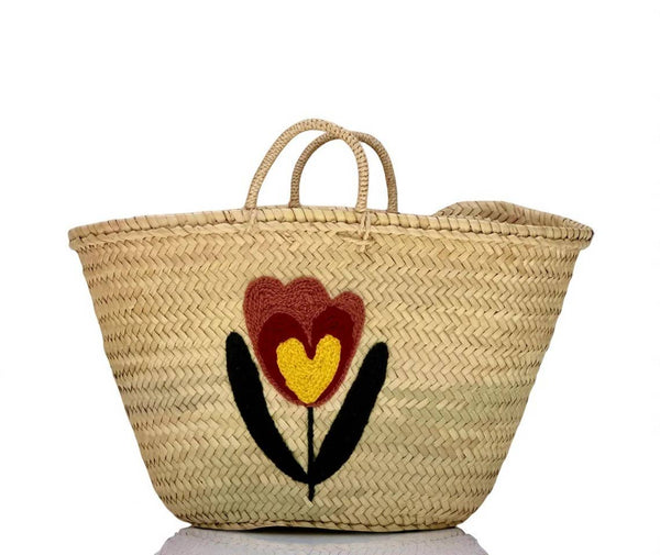 Woven basket with a floral design on a white background