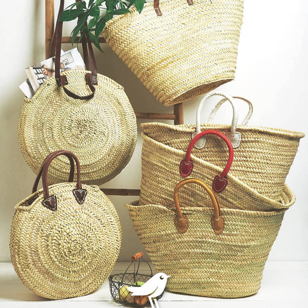 Set of woven baskets with handles on a white surface