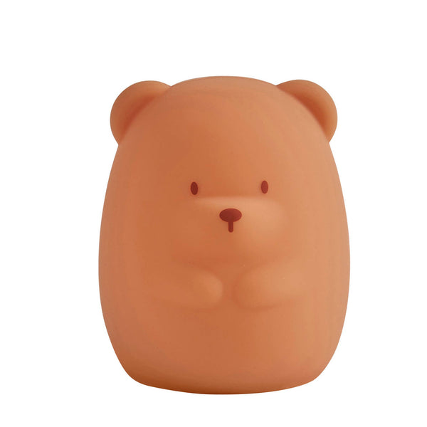 Brown bear-shaped night light on a white background