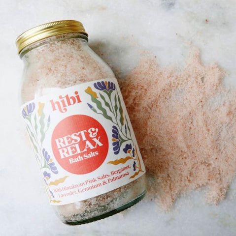 Jar of 'hibi' rest & relax bath salts on a marble surface