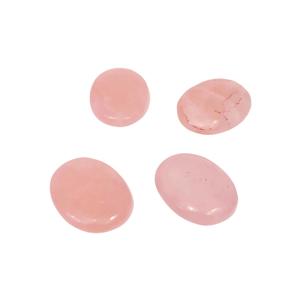 Four pink rose quartz stones on a white background