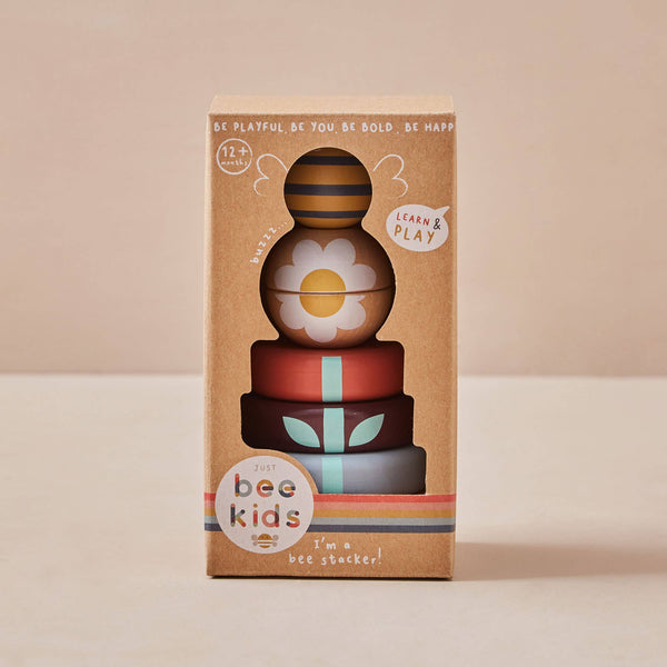 Stack of colourful wooden toys with 'bee kids' branding on a beige background