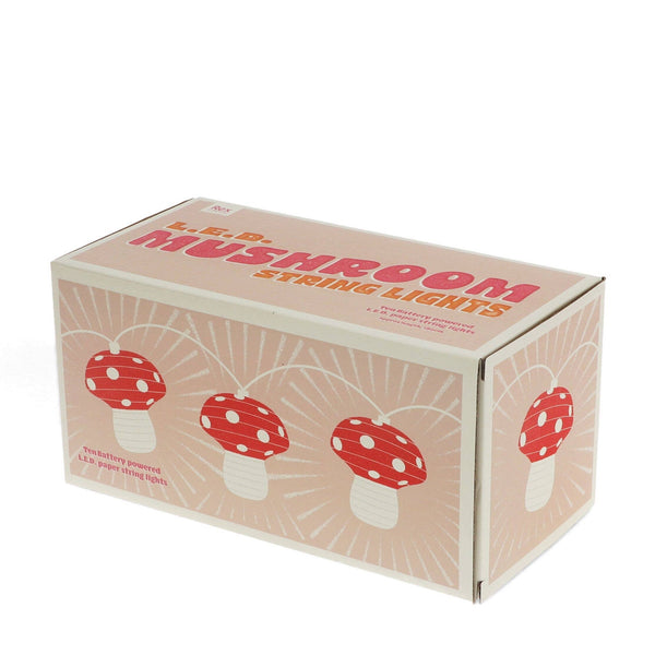 Box of mushroom string lights with red and white mushrooms on a beige background