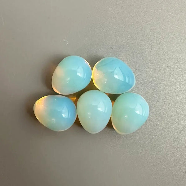 Five light blue stones on a grey background