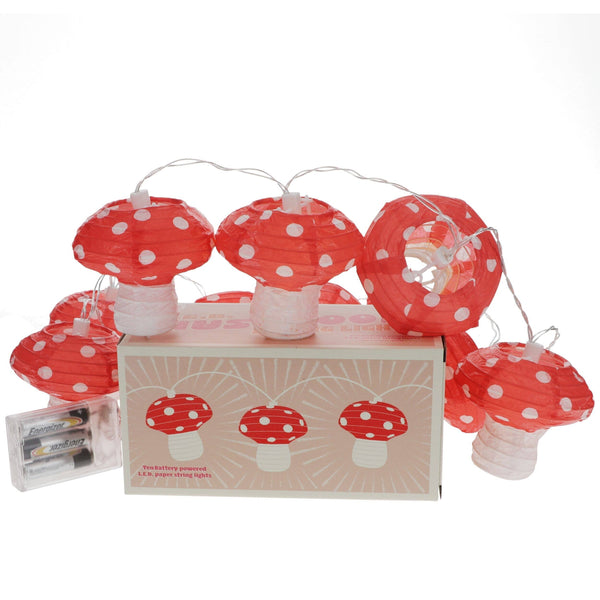 Red and white polka dot mushroom string lights with packaging on a white background