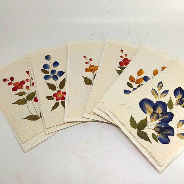Set of floral cards on a white surface