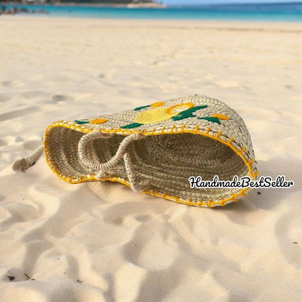 Handmade bag with decorative elements on a sandy beach