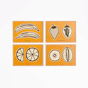 Set of four orange cards with black and white illustrations of fruits on a white background.