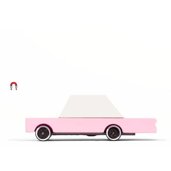 Pink toy car with a white roof on a white background
