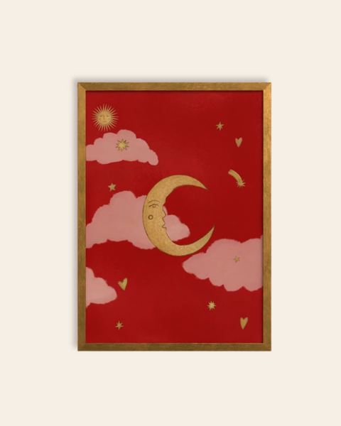 Framed artwork with a red background, gold crescent moon, pink clouds, and stars.
