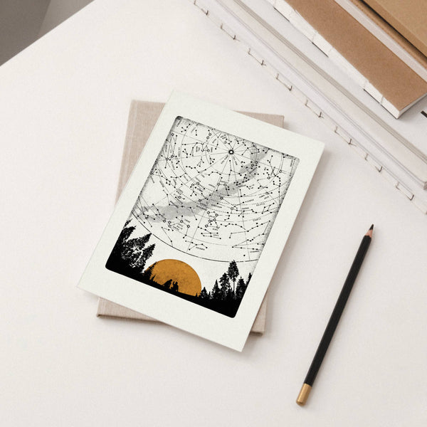Star map card with a pencil on a light surface