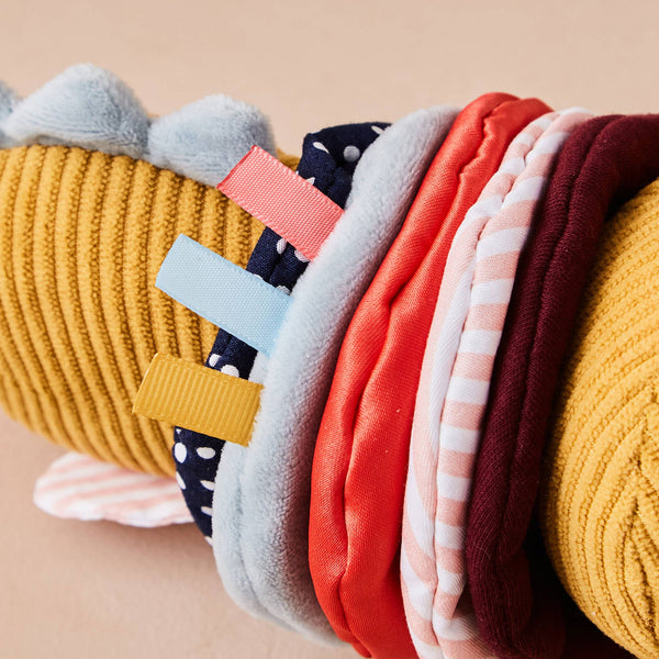 Colorful knitted toy on a beige background