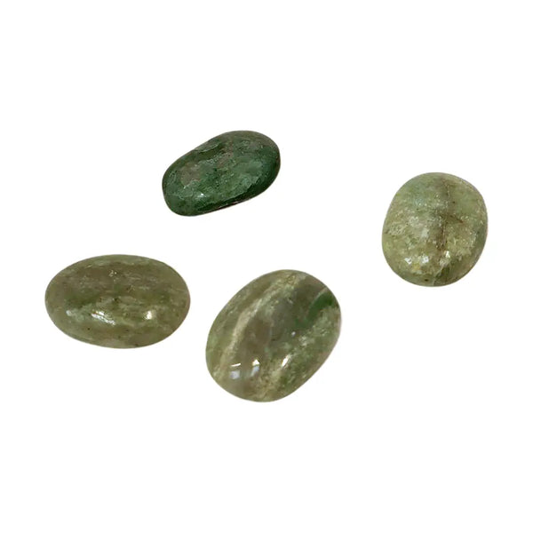 Four green stones on a white background