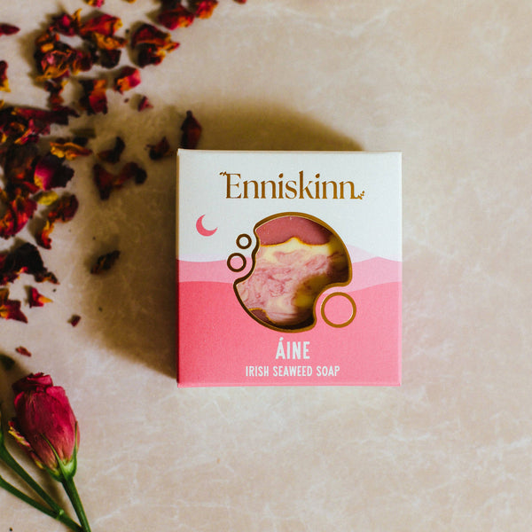 Enniskinn Irish Seaweed Soap packaging on a textured surface with dried flowers.