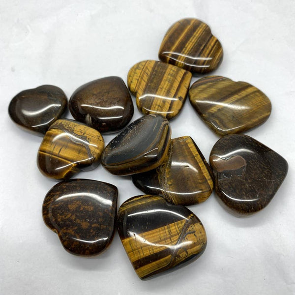 Collection of heart-shaped tiger's eye stones on a white background
