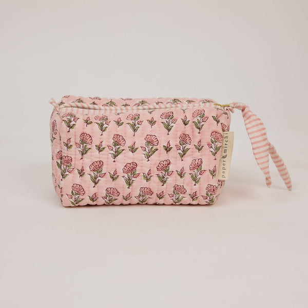 Pink floral patterned pouch with striped pull on a light background