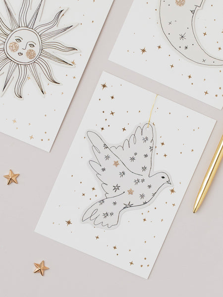 Paper decorations with celestial designs on a light surface