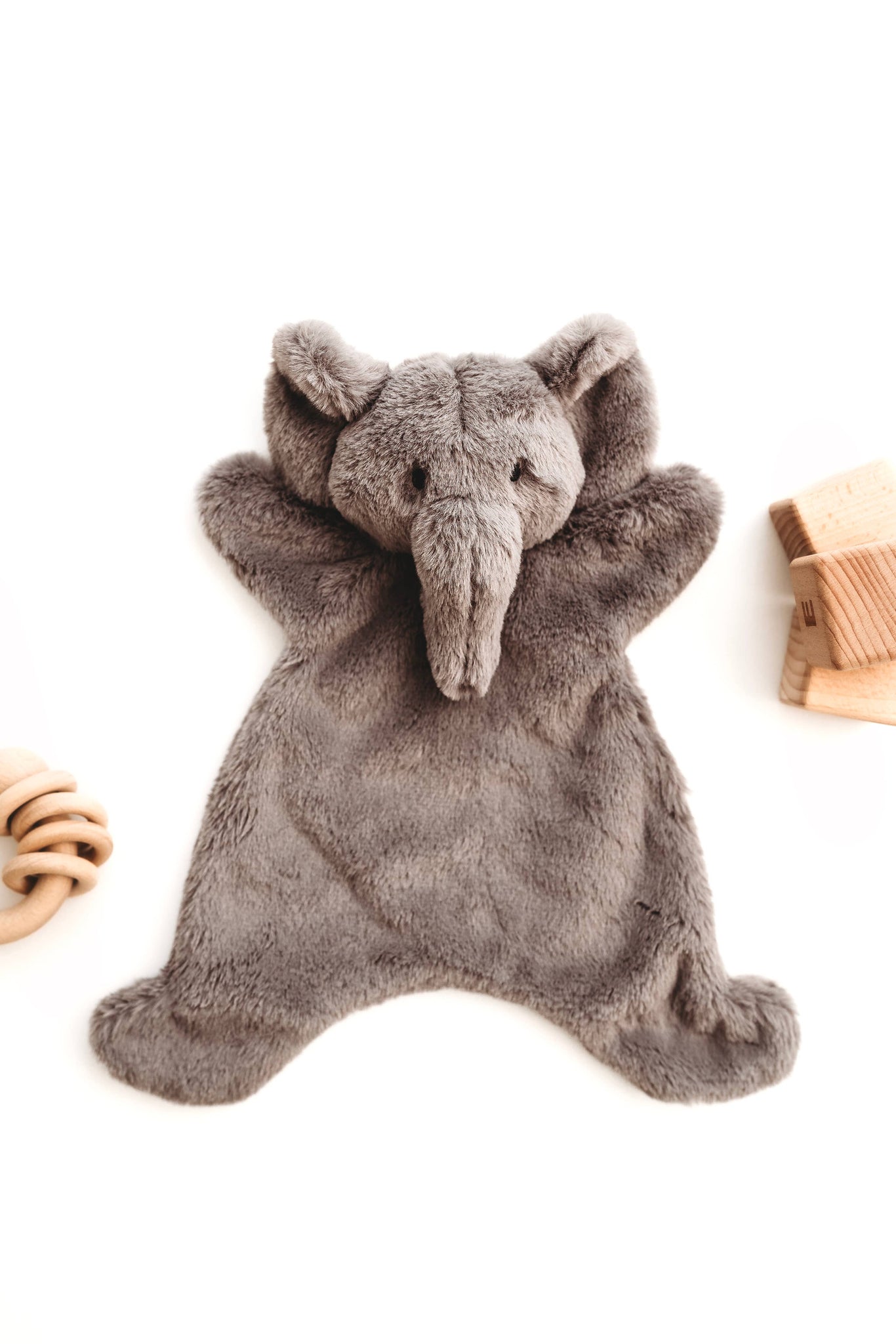 Gray plush elephant baby snuggler on a white background