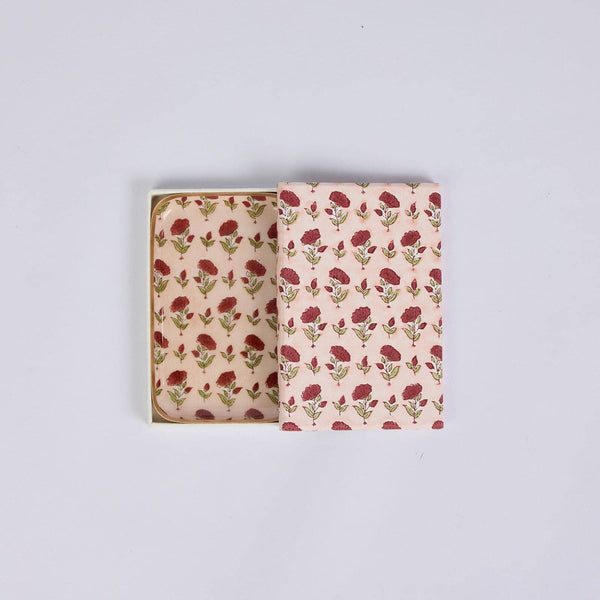 A small trinket tray with a pink floral pattern, shown with the box partially open to reveal the tray inside. The design features red flowers and green leaves on a light pink background.