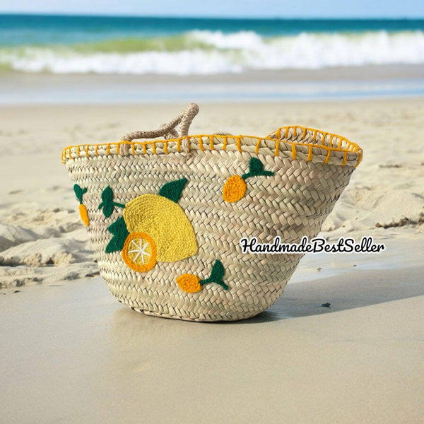 Woven bag with lemon design on a sandy beach