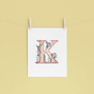 Poster with a decorative letter 'K' design on a yellow wall.