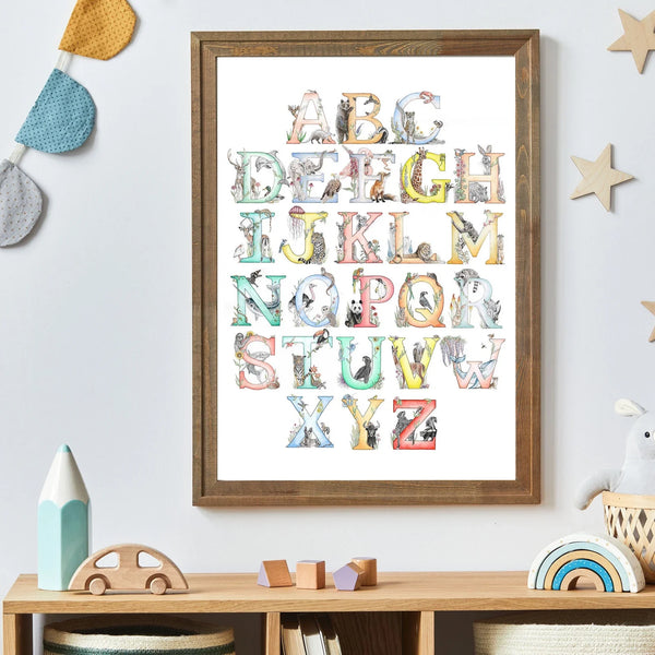Framed alphabet poster with animal illustrations on a wall above a shelf with children's toys.