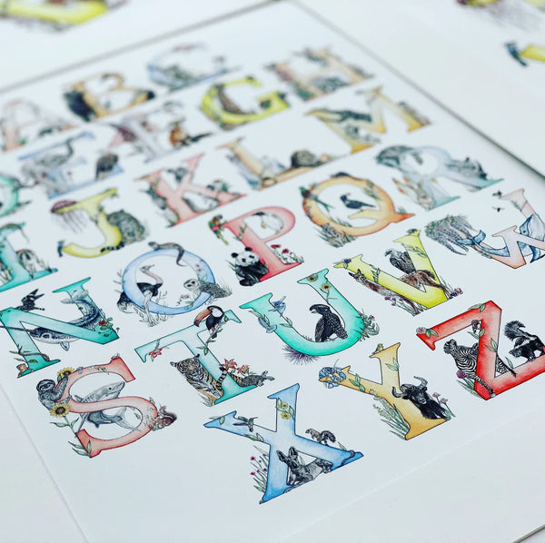 Alphabet chart with animal illustrations for each letter on a white background