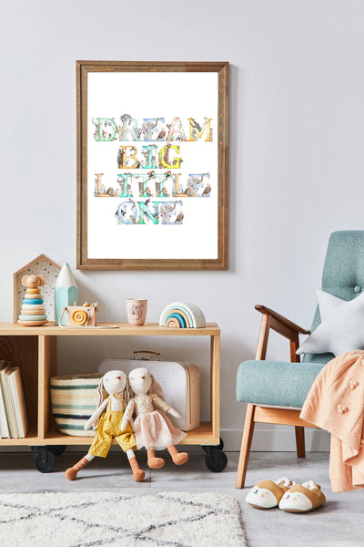 Framed artwork with colorful text in a child's room with toys and furniture.