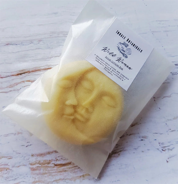 Yellow soap bar with face design on a white background, featuring a label.