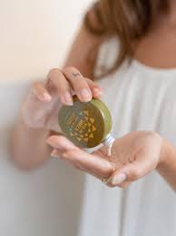 Person holding a small bottle of Sol de Ibiza Face & Body Magic Sun Oil against a plain background