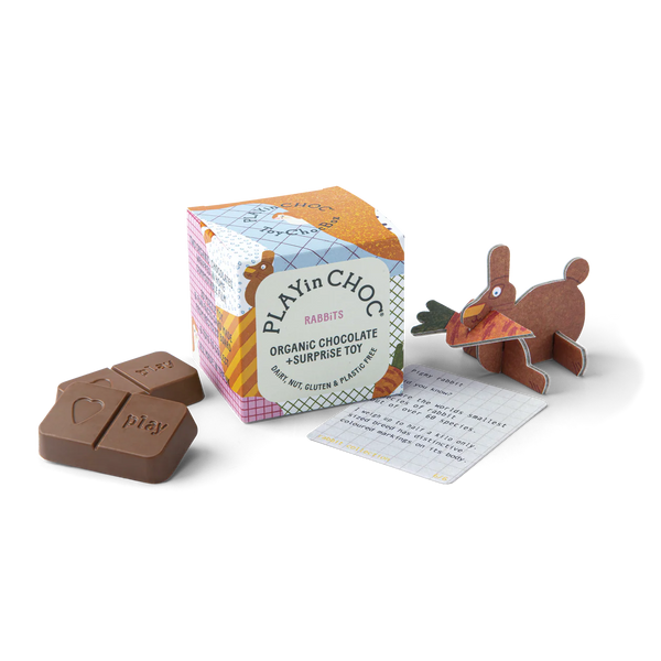 Playful chocolate and rabbit toy with packaging on a white background
