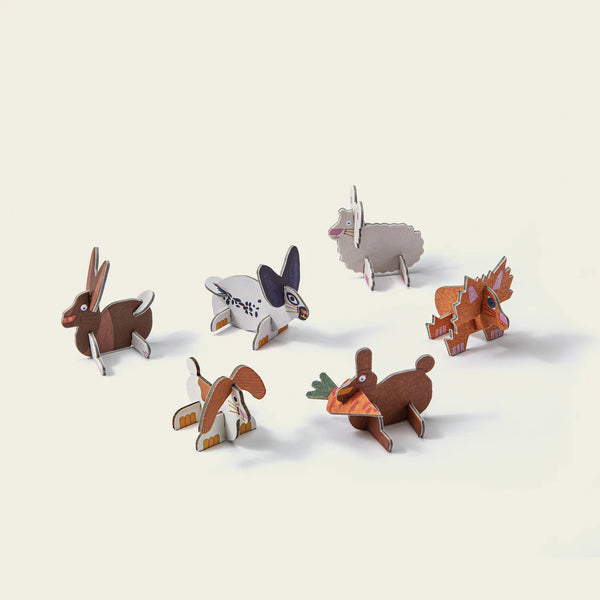 Set of small rabbit figurines on a light background