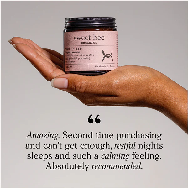 Hand holding a jar of 'sweet bee' organics product with a quote below.