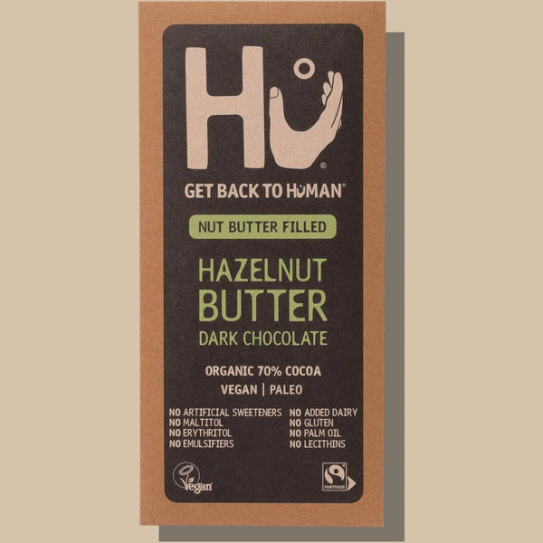 HU Nut Butter dark chocolate bar on a beige background