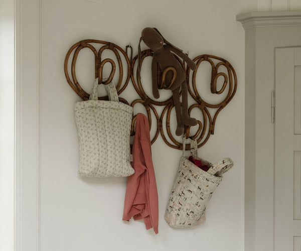 Happy Horse and Madelaine Quilted Tote Bags hanging in a hallway - Maileg