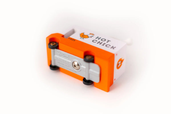 View of the base of an orange wooden toy van with a 'Hot Chicken' text label