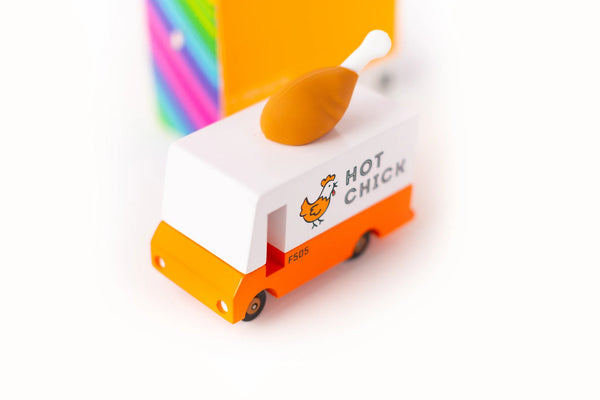 An orange wooden toy van with a 'Hot Chicken' text label and a rubber drumstick topper designed to look like a chicken.